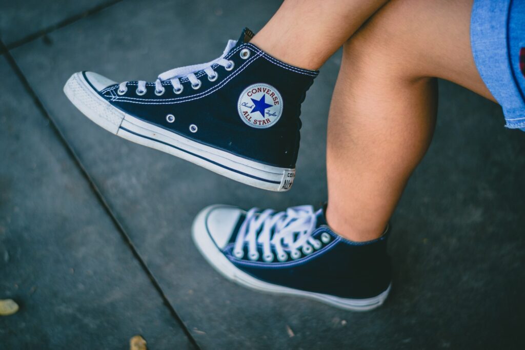 Person wearing black Converse All-star sneakers