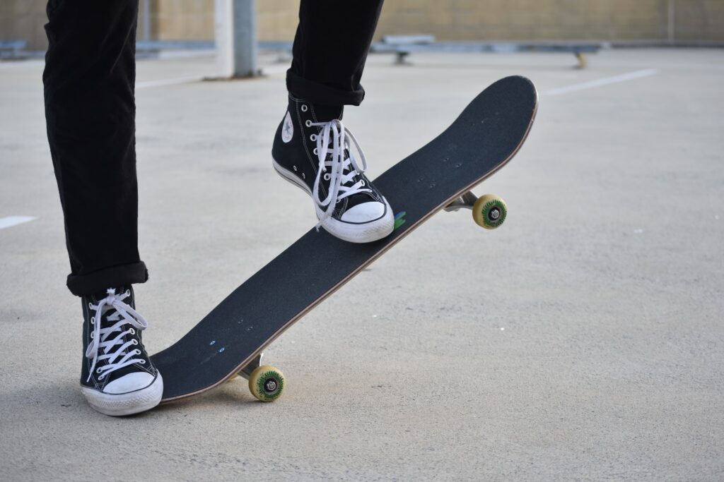 Person in black pants and black Converse sneakers