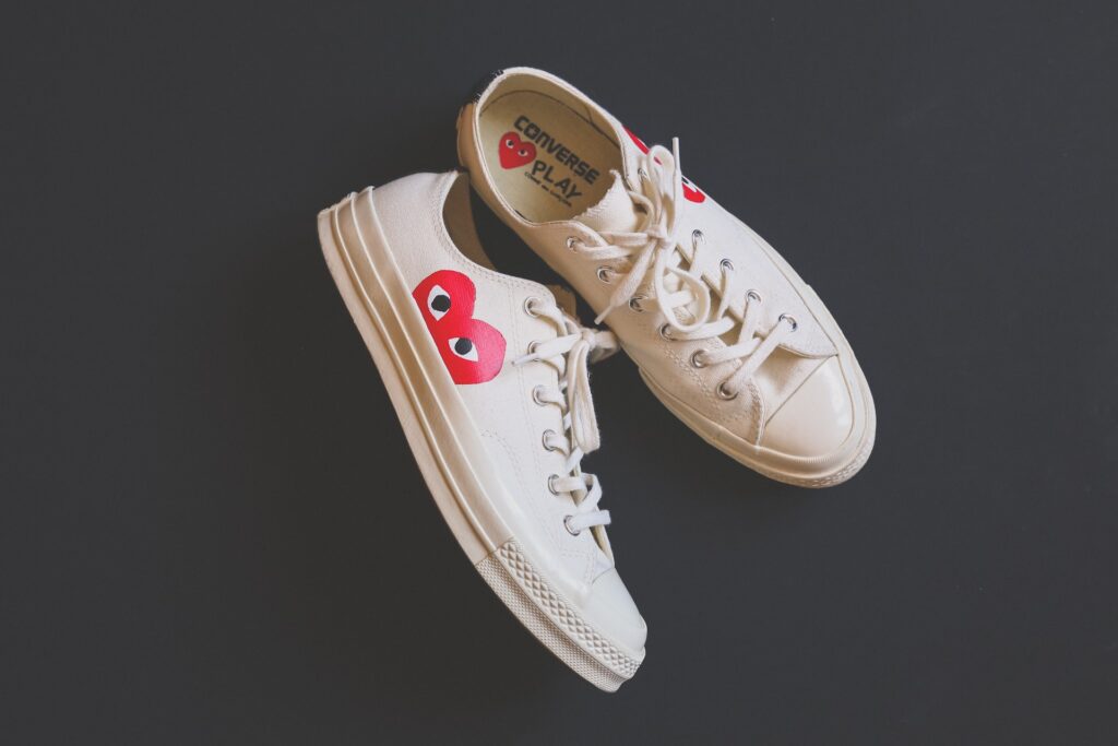 Pair of women's white sneakers from the Converse x CDG collaboration