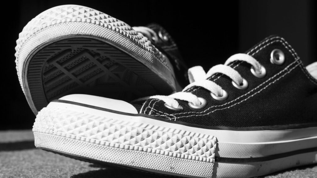 Close up shot of black low top Converse trainers