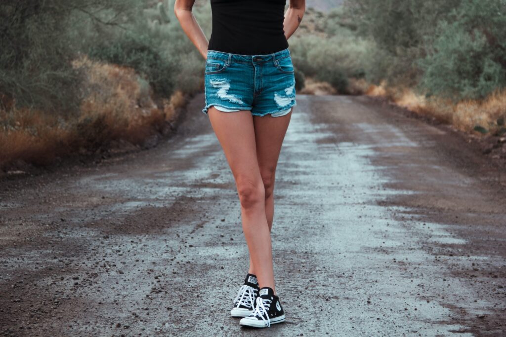Woman wearing Black Converse with shorts
